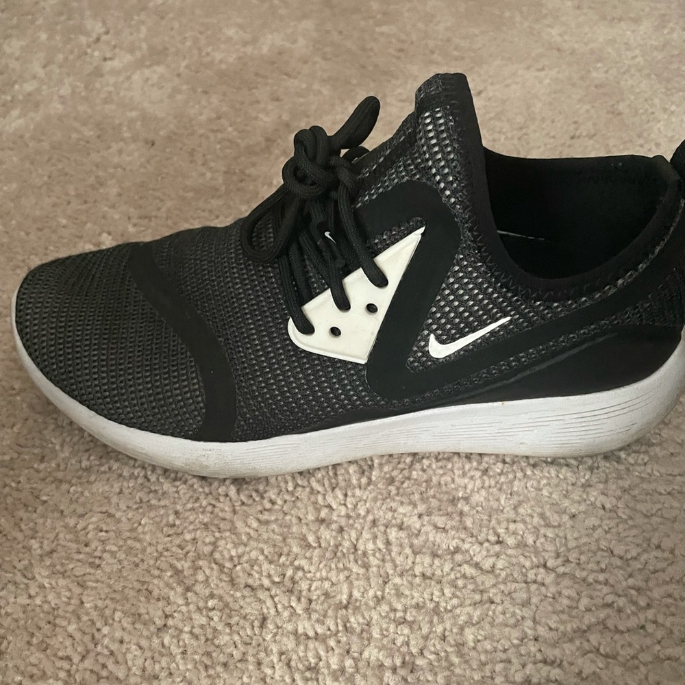 Nike- worn sneakers with small tear in back